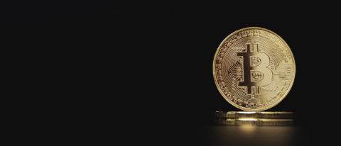 Golden bitcoins stacking on black background